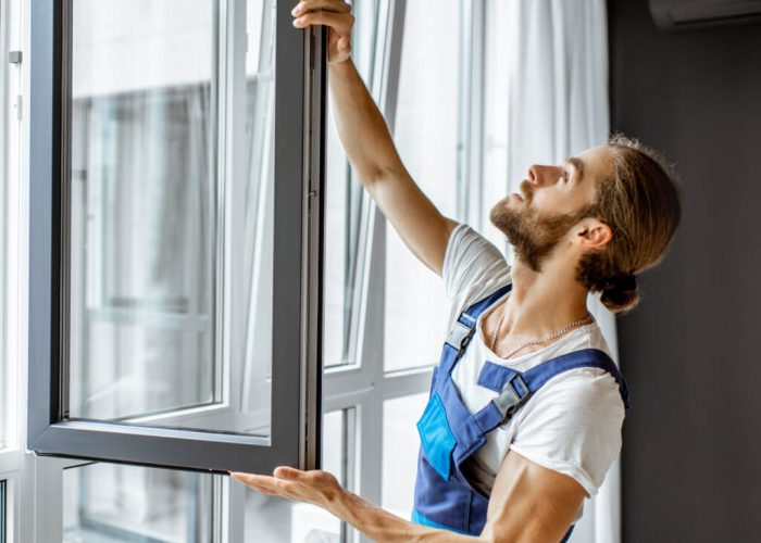 workman-adjusting-window-frames-at-home-2021-10-13-18-27-58-utc